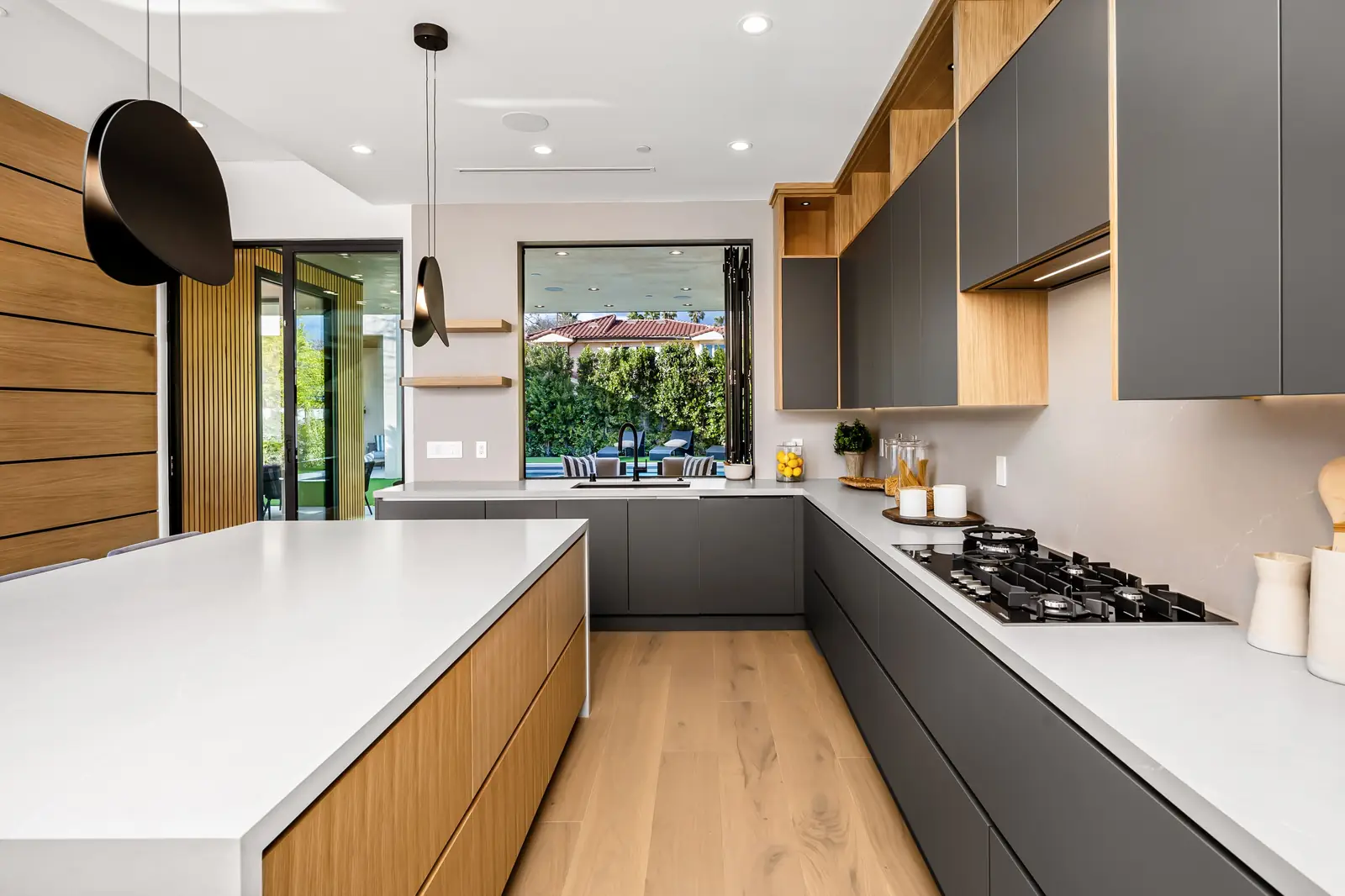 Modern kitchen with gray upper cabinets and a wood island