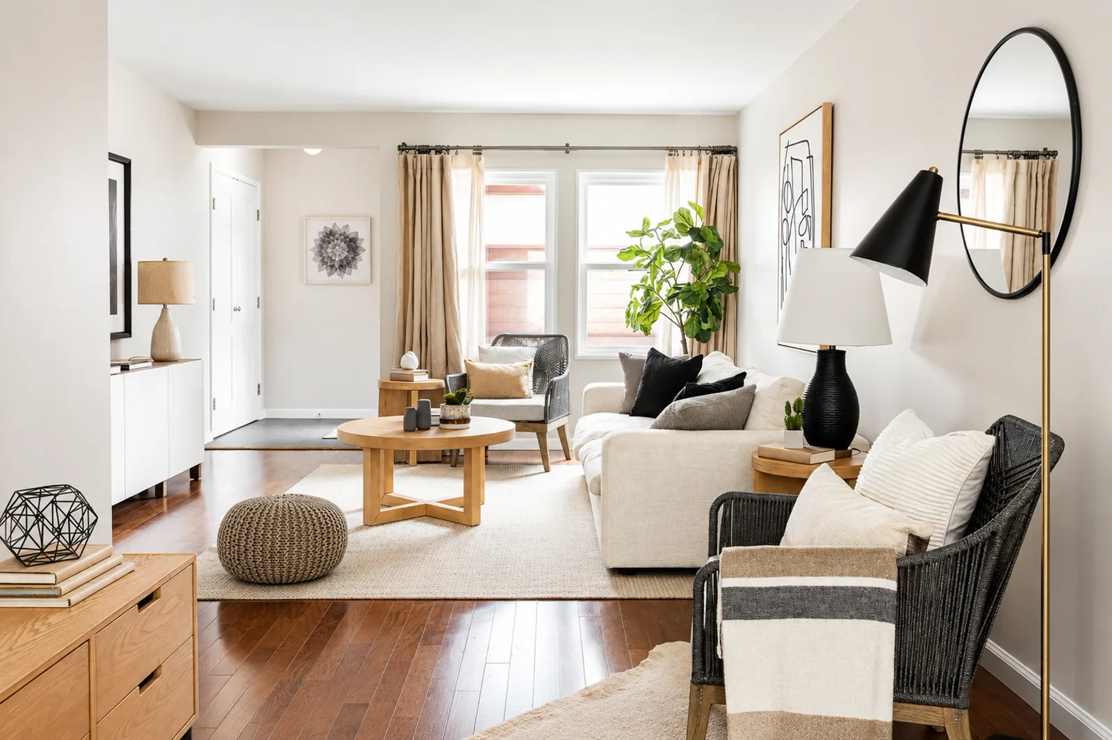 Bright living room with warm white walls, crisp white trim and hardwood floors