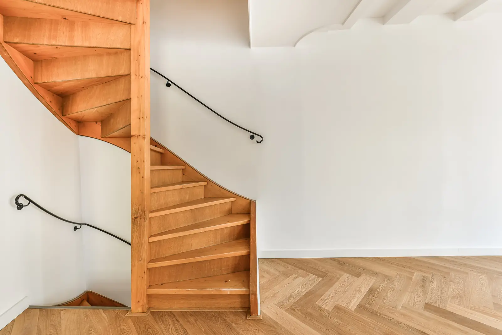 Spiral staircase in natural wood with the grain showing